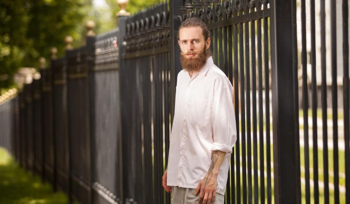 Maintenance for ornamental black aluminum fencing in Fargo, ND, featuring decorative gold finials.